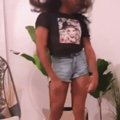 a person wearing shorts and a t-shirt with a picture of a woman on it