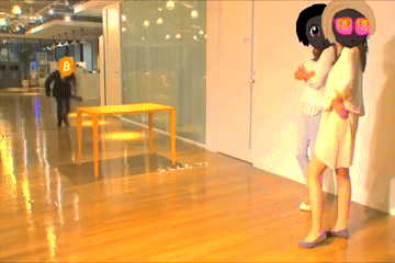 A Person With A B On Their Head Standing Next To A Woman GIF