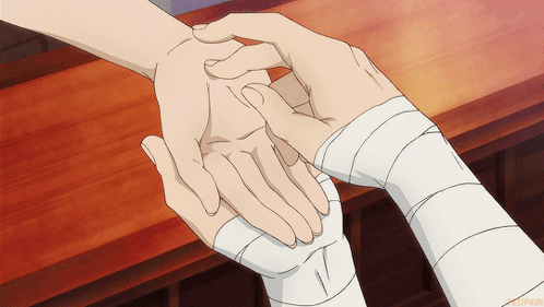 A Person With A Bandage On Their Wrist Is Holding Another Person 'S Hand GIF