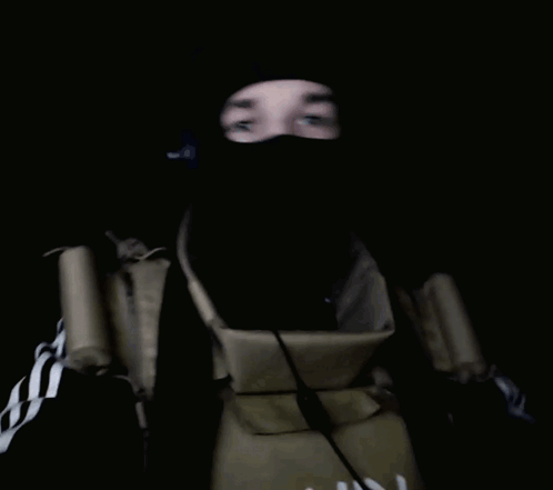 A Person With A Bandaged Hand Is Wearing A Mask And Giving The Middle Finger GIF