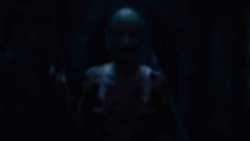 a person with a cage around their head has the letter s on their chest