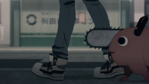 A Person With A Chainsaw Standing Next To A Cartoon Character GIF