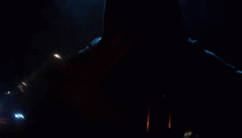 A Person With A Red Lightsaber In Their Hand GIF