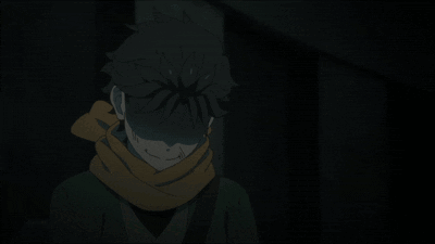 A Person With A Scarf Around Their Neck Stands In The Dark GIF
