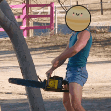 A Person With A Smiley Face On Their Face Is Using A Chainsaw To Cut A Tree GIF