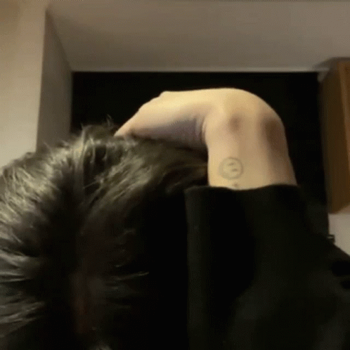 A Person With A Smiley Face Tattoo On Their Arm GIF