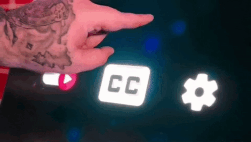 A Person With A Tattoo On Their Wrist Is Pointing At A Screen With A Cc Icon And A Gear Icon . GIF