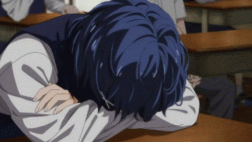 A Person With Blue Hair Is Laying Down On A Desk GIF
