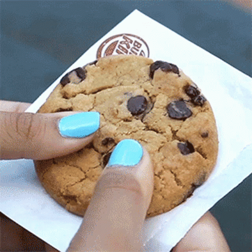 A Person With Blue Nail Polish Is Holding A Burger King Chocolate Chip Cookie GIF
