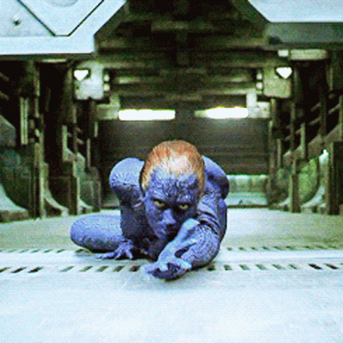 A Person With Blue Paint On Their Body Is Crawling On The Ground GIF