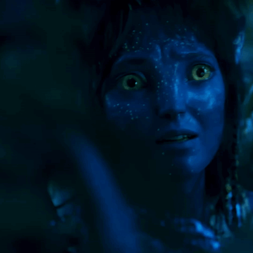 A Person With Blue Paint On Their Face Is Covering Their Mouth With Their Hand GIF