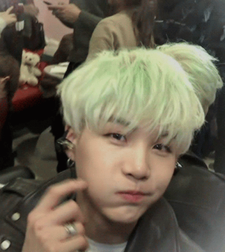 A Person With Green Hair Is Making A Face GIF