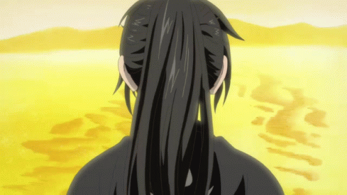 A Person With Long Black Hair Is Standing In A Desert GIF
