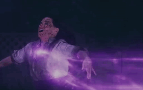 A Person With Purple Smoke Coming Out Of Their Mouth GIF