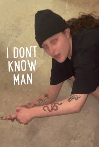 A Person With Red Eyes And A Tattoo On Their Arm Says " I Dont Know Man " In White Letters GIF