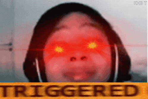 A Person With Red Eyes And The Word Triggered In The Corner GIF
