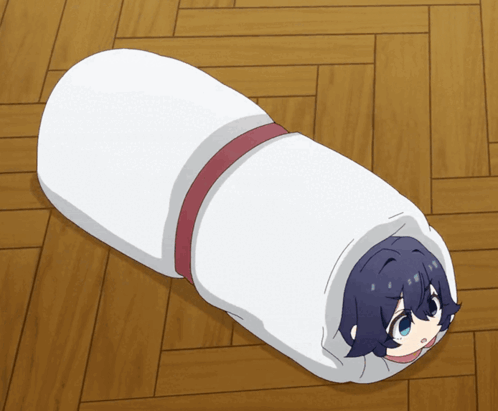 A Person Wrapped In A White Blanket With A Red Ribbon GIF