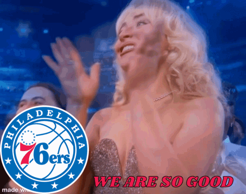 a philadelphia 76ers logo is behind a woman in a dress
