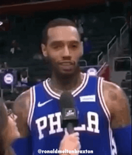 A Philadelphia Basketball Player Is Talking Into A Microphone GIF