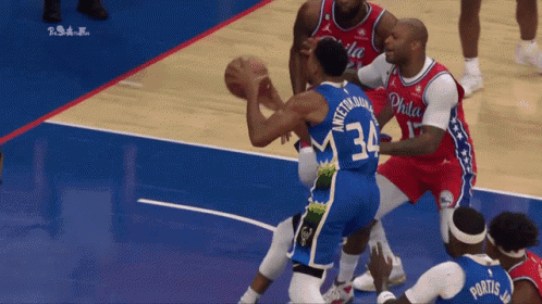 A Philadelphia Basketball Player Wearing Number 34 Tries To Block Another Player GIF