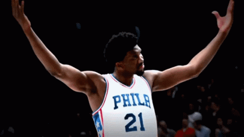 A Philadelphia Basketball Player With His Arms Outstretched In The Air GIF