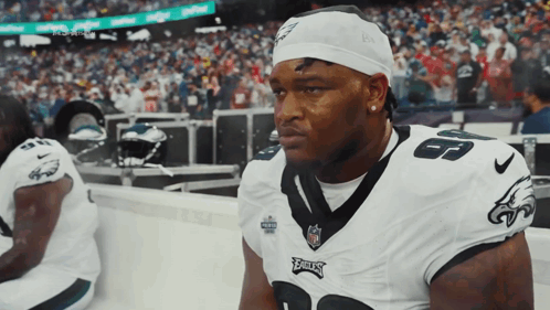 A Philadelphia Eagles Player Sits On The Sidelines During A Game GIF