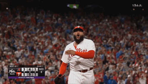 A Philadelphia Phillies Baseball Player Stands In Front Of A Scoreboard GIF