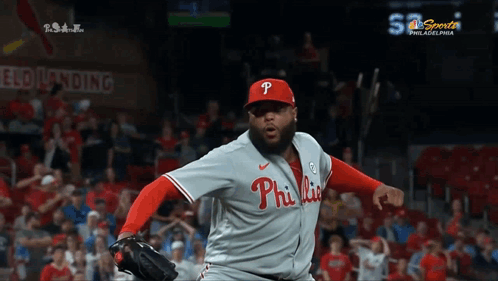 A Philadelphia Phillies Pitcher Throws A Ball In Front Of A Crowd GIF