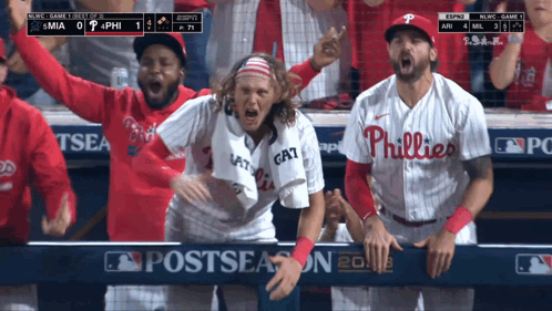 A Philadelphia Phillies Player Stands In The Dugout With His Teammates GIF