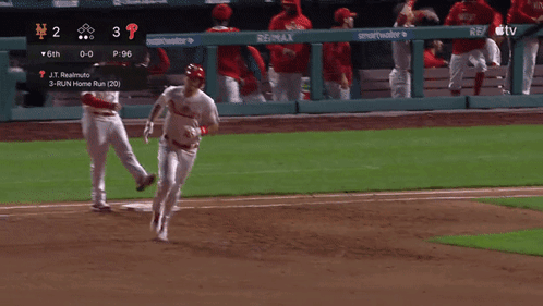 a phillies baseball player is running towards the base