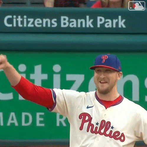 A Phillies Baseball Player Stands In Front Of A Citizen 'S Bank Park Banner GIF