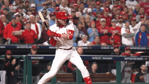 A Phillies Baseball Player Swings His Bat At The Ball GIF