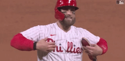A Phillies Baseball Player Wearing A Red Helmet And A White Jersey GIF