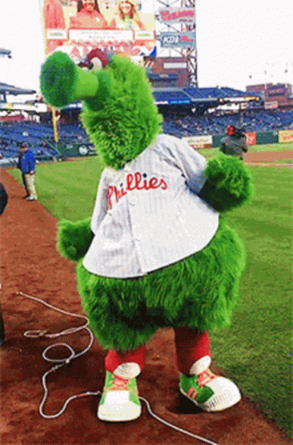 A Phillies Mascot Is Standing On The Field GIF