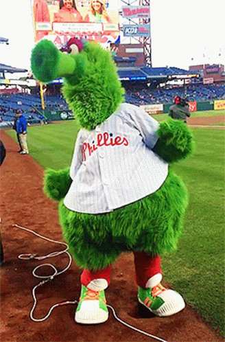 A Phillies Mascot Is Standing On The Field GIF