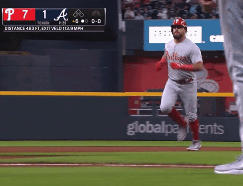 A Phillies Player Runs To First Base During A Game GIF