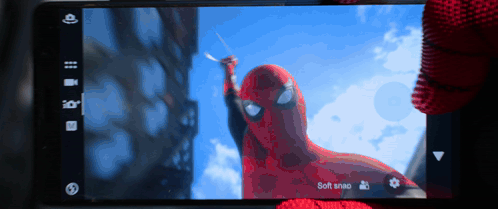 A Phone Screen Shows A Picture Of A Spiderman Holding A Sword And Says Soft Snap GIF