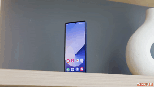 A Phone Sitting On A Shelf With The Words Thinkjules Below It GIF