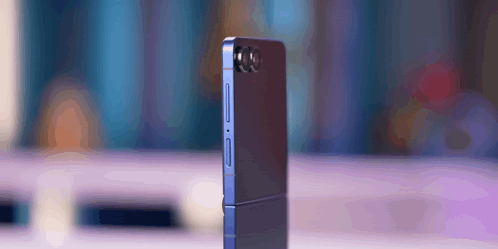 A Phone With A Camera On The Back Is Sitting On A Table GIF