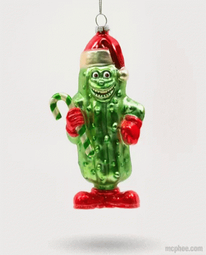 A Pickle Ornament With A Santa Hat And Candy Cane GIF