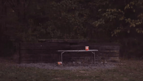 A Picnic Table With A Can Of Soda On It That Is On Fire GIF