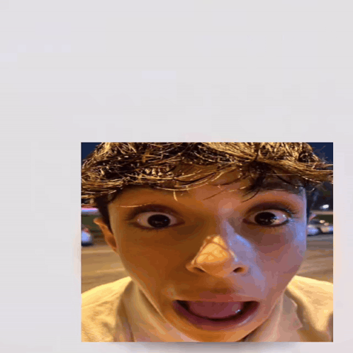 A Picture Of A Boy With His Tongue Out And The Word Holy Above Him GIF