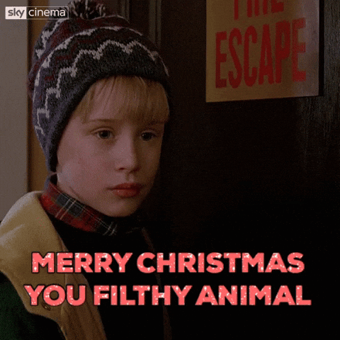 A Picture Of A Boy With The Words Merry Christmas You Filthy Animal Above Him GIF