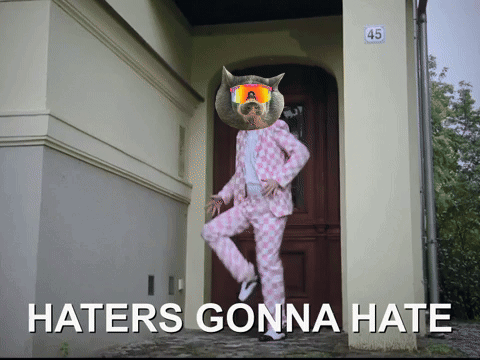 A Picture Of A Cat In A Pink Suit With Haters Gonna Hate Written On It GIF