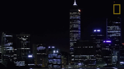 A Picture Of A City At Night With A National Geographic Logo GIF
