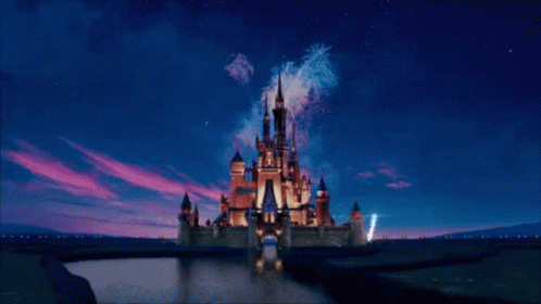 A Picture Of A Disney Castle With A Mickey Mouse Head In The Background GIF
