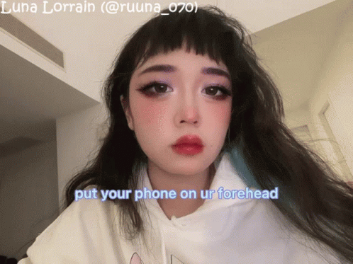 A Picture Of A Girl With The Words Put Your Phone On Ur Forehead GIF