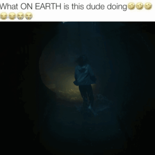 A Picture Of A Man Holding A Flashlight In A Dark Room With The Caption What On Earth Is This Dude Doing GIF