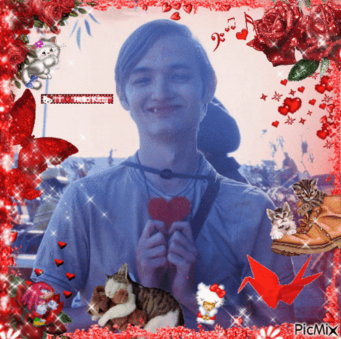 A Picture Of A Man Holding A Heart Is Surrounded By Red Flowers GIF