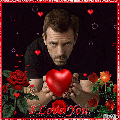 A Picture Of A Man Holding A Red Heart With The Words I Love You Written On The Bottom GIF